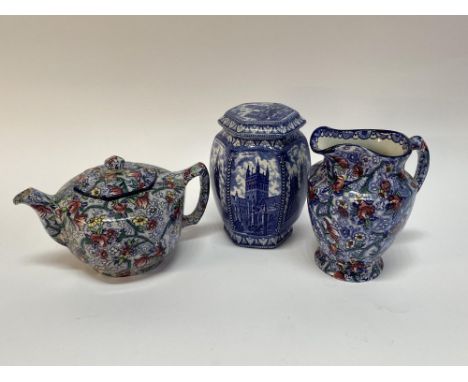 A Maling Ware Ringtons lidded storage jar depicting Cathedrals, 20cm H, a jug and a teapot