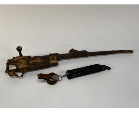 A rusty rifle and a knife holster