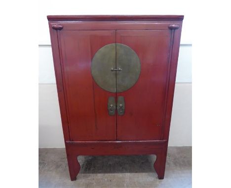 A Late 19th Century Chinese Red Painted Marriage Cabinet, with double cupboards which open to reveal two central drawers with