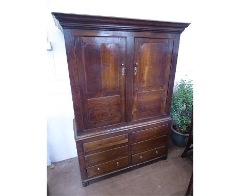 An Antique Oak Welsh Two Door Armoire/Linen Press Cupboard on square feet, double cupboard with two drawers beneath; the cupb