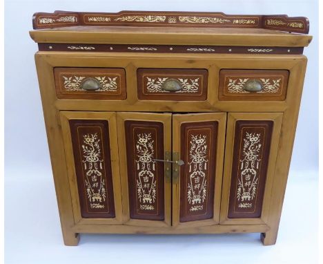 A 20th Century Chinese Cypress and Mahogany Tea Table, double cupboards with decorative foliate bone inlay, three short drawe