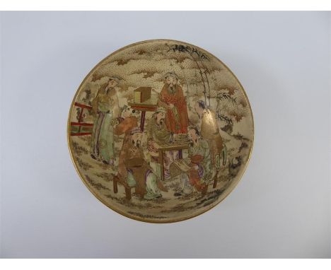 A 19th Century Japanese Earthenware Bowl, painted with figures playing boardgames, approx 14 x 7 cms.