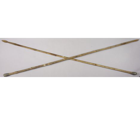 A pair of vintage eastern spears each with a bamboo handle, 214cm long.