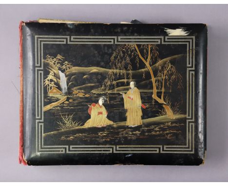 A Japanese black lacquered photograph album containing approximately seventy various vintage postcards &amp; family photograp