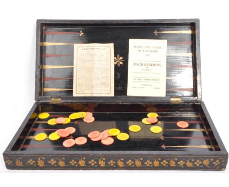 A vintage 19th century folding chess board/backgammon set. In ebonised wood with gilded detailing around edges, inlaid gilded