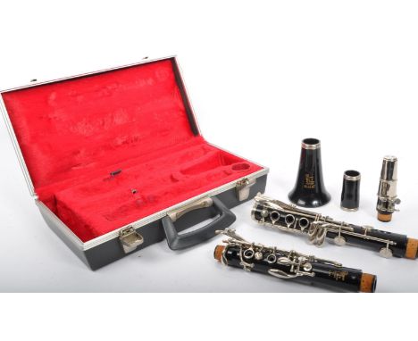 A Boosey &amp; Hawkes 'Regent' ebonised section clarinet in plush lined hard case.