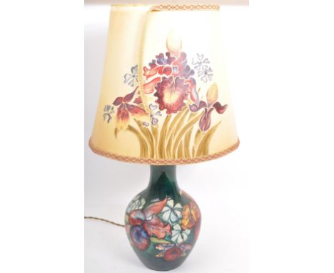 A vintage 20th century Moorcroft bone china hand painted desk table lamp base with shade in the 'Orchid' pattern. The lamp ba