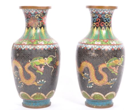 A pair of early 20th century Chinese Oriental cloisonne metal table vases having a flared tall neck over a bulbous shaped bod
