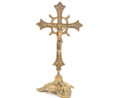 A vintage 20th century religious cross ecclesiastic tabletop crucifix ornament. With a decorative cross on a tripod foliate b