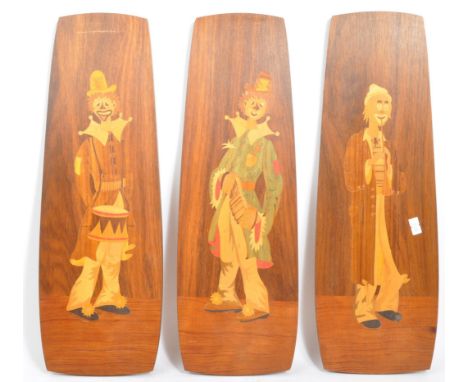 A set of three retro vintage mid 20th century mahogany Italian inspired inlaid wall plaques depicting clowns in various posit