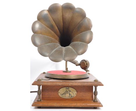 A vintage reproduction electric record player in the form of an antique horned gramophone, with brass horn & fittings. Dimens