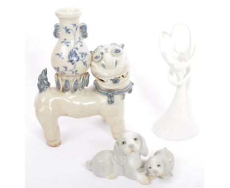 A vintage 20th century ceramic pottery Asian Chinese figure of a Fu Dog with stem vase in blue and white. Together with St Mi