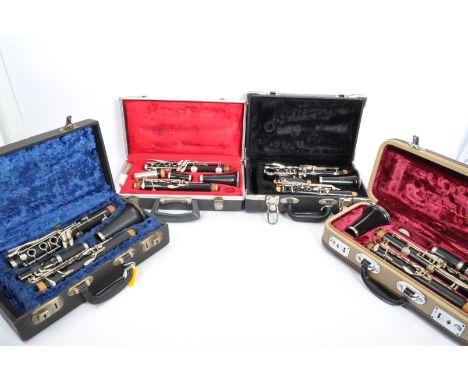 A collection of four vintage clarinets in hard fitted cases. The lot to include a Lewington Model 41 clarinet, a BH 'La Fleur
