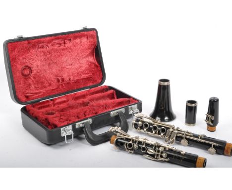 A Boosey &amp; Hawkes 'Regent' ebonised section clarinet in plush lined hard case.