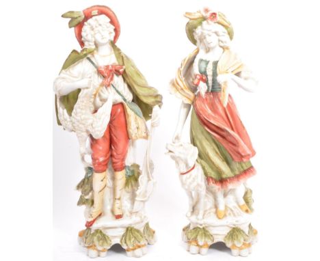 A pair of early 20th century continental bisque ware figures depicting a classical couple. With a gentleman hunting holding g