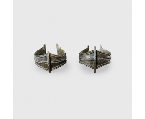 PAIR OF IRON AGE BRACELETS CENTRAL OR EASTERN EUROPE, 300 - 500 A.D. cast bronze, each with scooped edges, double ropework bo