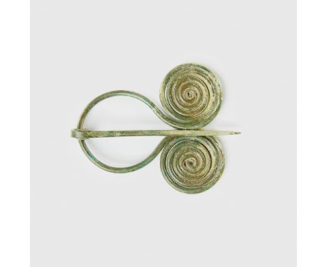 BRONZE AGE PENANNULAR SPIRAL BROOCH CENTRAL EUROPE, C. 1200 B.C. copper alloy, dual opposing flattened coil spirals conjoined