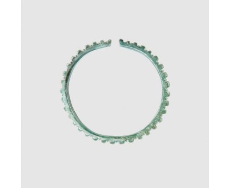 CELTIC BRACELET CENTRAL EUROPE, HALLSTATT CULUTRE, C. EARLY FIRST MILLENNIUM B.C. cast bronze, of penannular form, with a rep