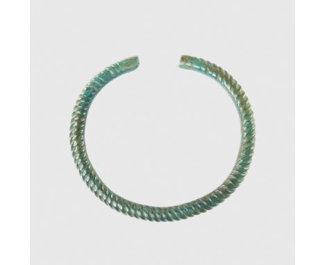 CELTIC ARM RING WESTERN EUROPE, 8TH CENTURY B.C. cast copper alloy, of thick overall construction, twisted and with flattened