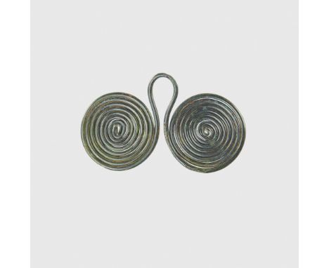 BRONZE AGE SPIRAL PENDANT CENTRAL EUROPE, C. 1200 B.C. copper alloy, formed as two coils of round section rod with a loop bet