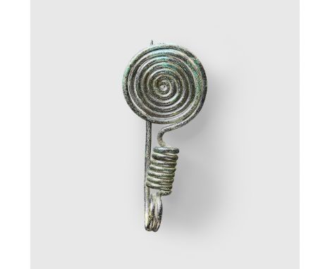 BRONZE AGE SPIRAL BROOCH CENTRAL EUROPE, C. 11TH - 10TH CENTURY B.C. copper alloy, formed from a single wire, a flat coiled p