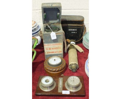 A Type 06 A military compass No. 19807D, in carrying box, a small circular metal aneroid barometer, 9cm diameter, a similar c