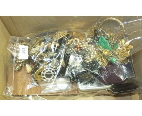 A quantity of costume jewellery, including long sphinx ear drops and a faux jade necklace.