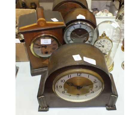 Three oak mantel clocks, a mahogany mantel clock and a 400-day clock under plastic dome.
