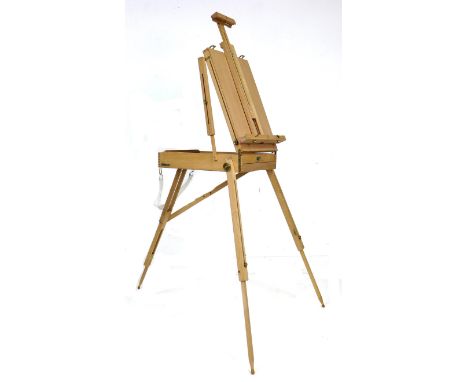 A modern wooden artist's travelling easel, with fold-away legs, and white cotton carry strap, 40.5 by 70.5 by 62cm high. 