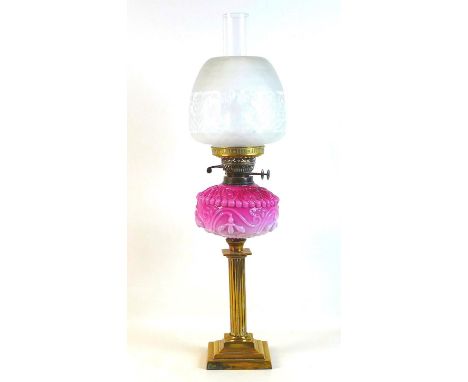 A Victorian paraffin lamp, with pink moulded glass reservoir, brass reeded column, etched clear glass shade and clear glass c