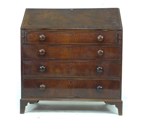 An early 19th century mahogany bureau, fall front with fitted interior, over four graduating drawers with cock beading and tu