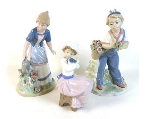 A Nao figure group of a girl with a puppy, 17cm high together with a pair of Rex limited edition figures of a girl with a wat