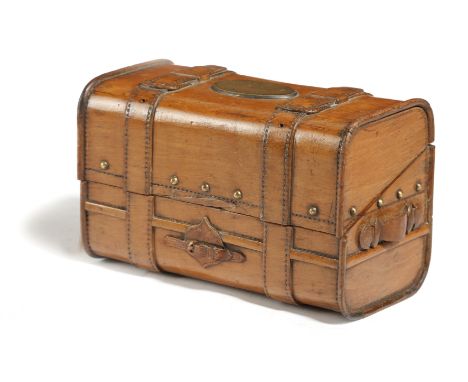 A FRENCH CARVED FRUITWOOD BOX IN THE FORM OF A TRUNK LATE 19TH CENTURY the hinged lid with a vacant brass plaque, the interio