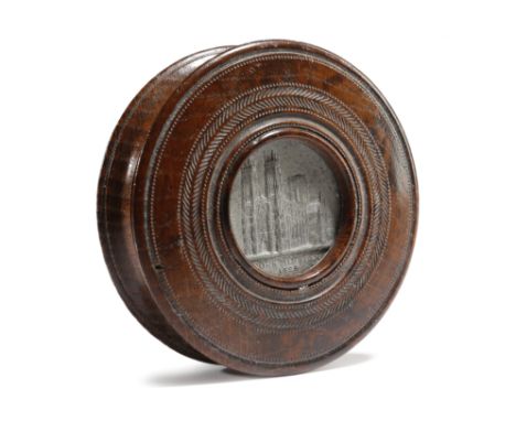 A GEORGE IV OAK 'YORK MINSTER' CIRCULAR SNUFF BOX EARLY 19TH CENTURY engine turned, the lid inset with a silver medallion, on