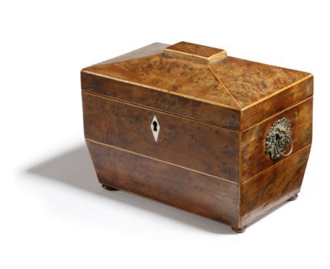 A REGENCY BURR YEW TEA CADDY EARLY 19TH CENTURY of sarcophagus shape, inlaid with boxwood stringing and with a bone escutcheo