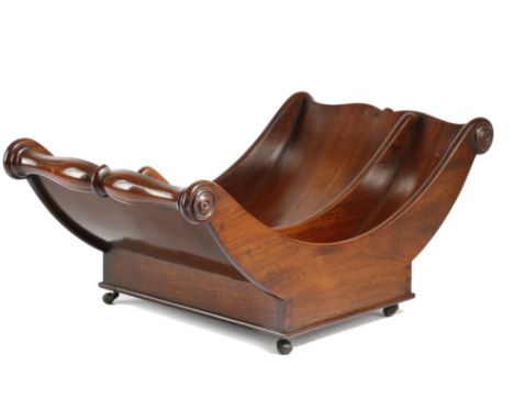 A REGENCY MAHOGANY CHEESE COASTER EARLY 19TH CENTURY with twin-split baluster lifts and two divisions, on leather roller cast