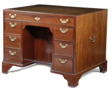 A GEORGE II MAHOGANY KNEEHOLE DESK MID-18TH CENTURY the caddy moulded edge top inset with a later gilt tooled brown leather w