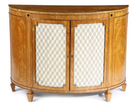 A LATE GEORGE III SATINWOOD DEMI-LUNE COMMODE EARLY 19TH CENTURY inlaid with ebonised stringing and stars, the top crossbande
