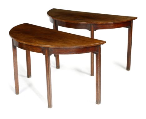 A PAIR OF GEORGE III MAHOGANY CONSOLE TABLES LATE 18TH CENTURY, FORMERLY THE ENDS OF A DINING TABLE each with a demi-lune top