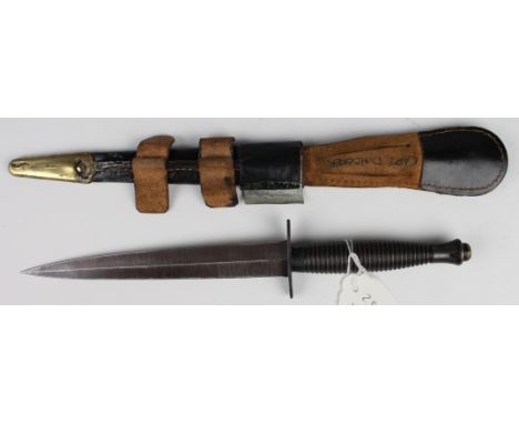 Commando Dagger in leather scabbard (repaired), cross guard stamped 'William Rogers, Sheffield England'. 