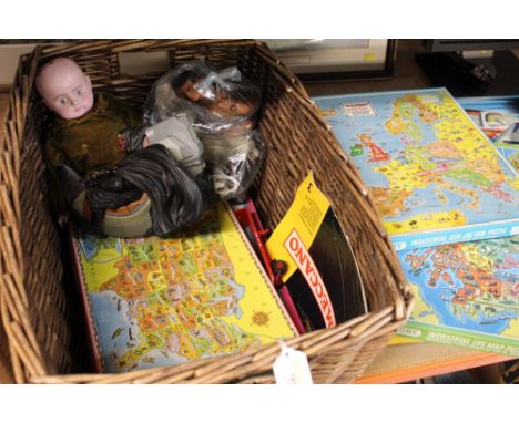 Wicker basket containing vintage action figures, doll and jigsaw puzzles 