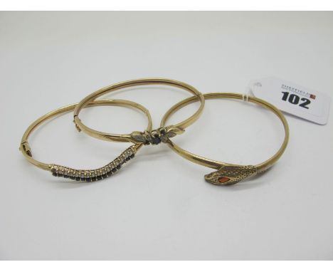 A 9ct Gold Serpent Bangle, with inset highlights to head; Together with Two Hinged Bangles, each with claw set highlights (on