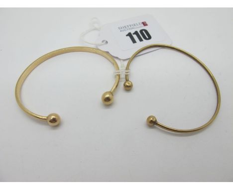 A Child's Torque Bangle, indistinctly stamped; together with another example, stamped "375". (2)