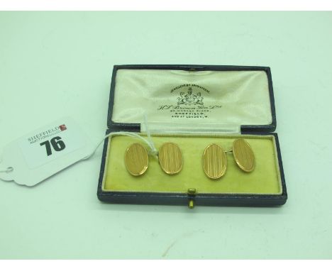 A Pair of 9ct Gold Cufflinks, the oval engine turned panels on chain connections, in a fitted case.