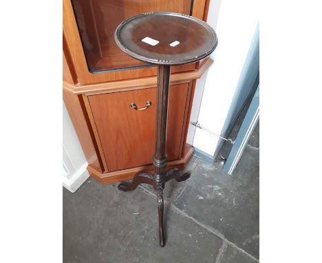 A tripod table with reeded column on pad feet 