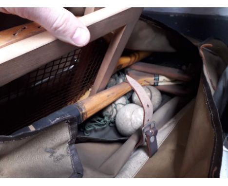 A bag containing vintage tennis rackets 