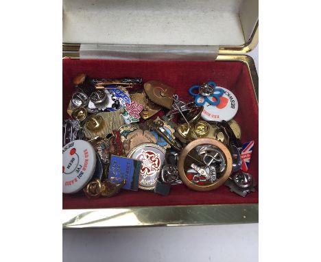 A box of vintage pin badges 