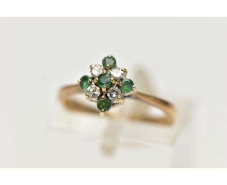 A 9CT GOLD EMERALD AND DIAMOND CLUSTER RING, of a diamond shape, set with five circular cut emeralds and four round brilliant