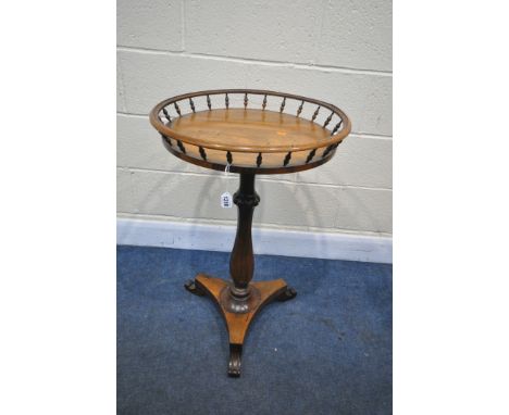 A VICTORIAN ROSEWOOD CIRCULAR TRIPOD TABLE, with a spindled gallery, on a nonagon shaped, triform base, and scrolled feet, di