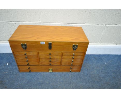 A THOMAS PACCONI CLASSICS LIGHT OAK COLLECTORS' CHEST, with a hinged lid, fourteen various drawers, with twin handles to the 